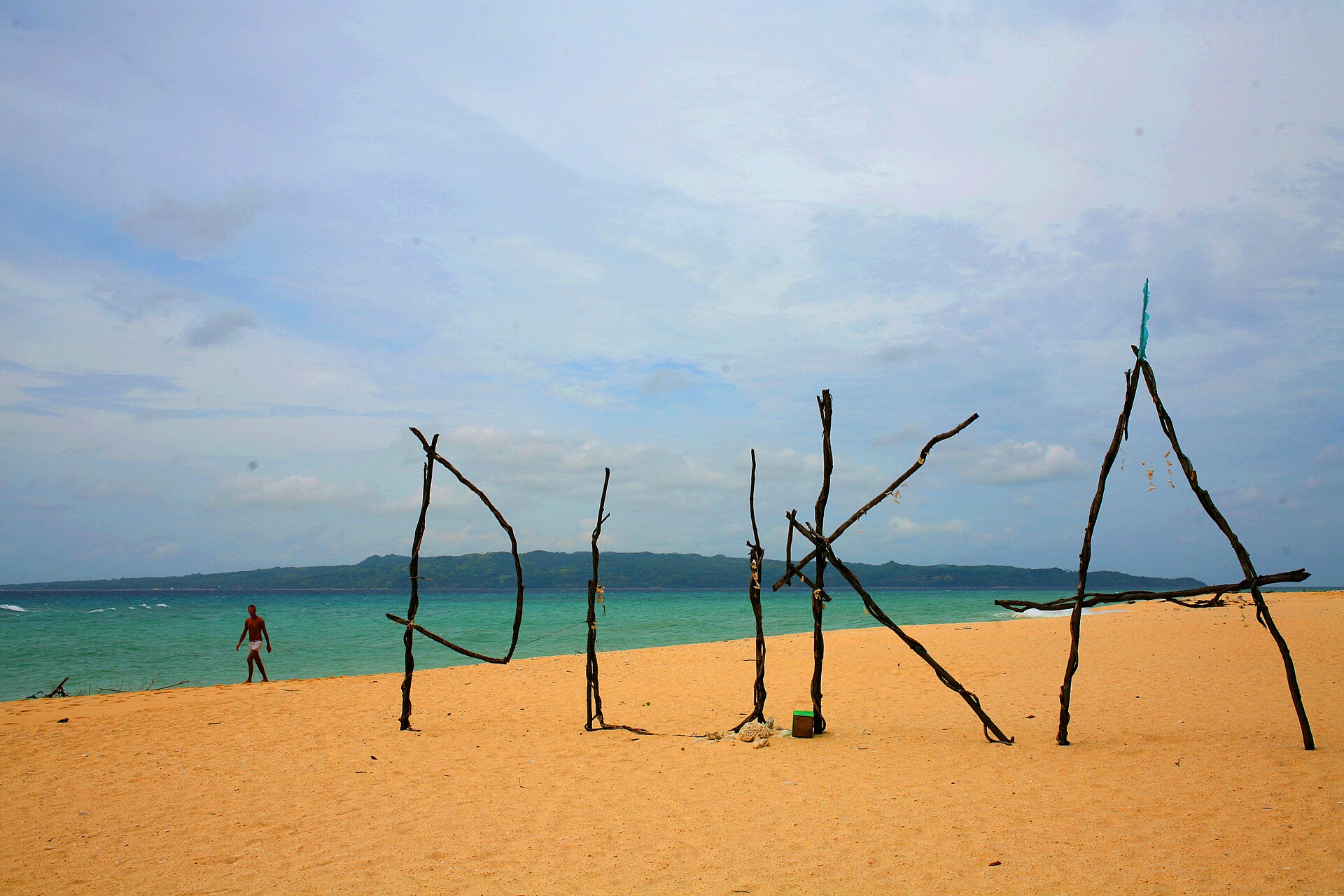 Puka Beach, Boracay, with driftwood letters spelling PUKA on the sand